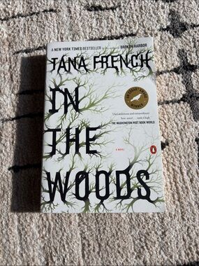 In the Woods by Tana French — White & Green Paperback Novel
